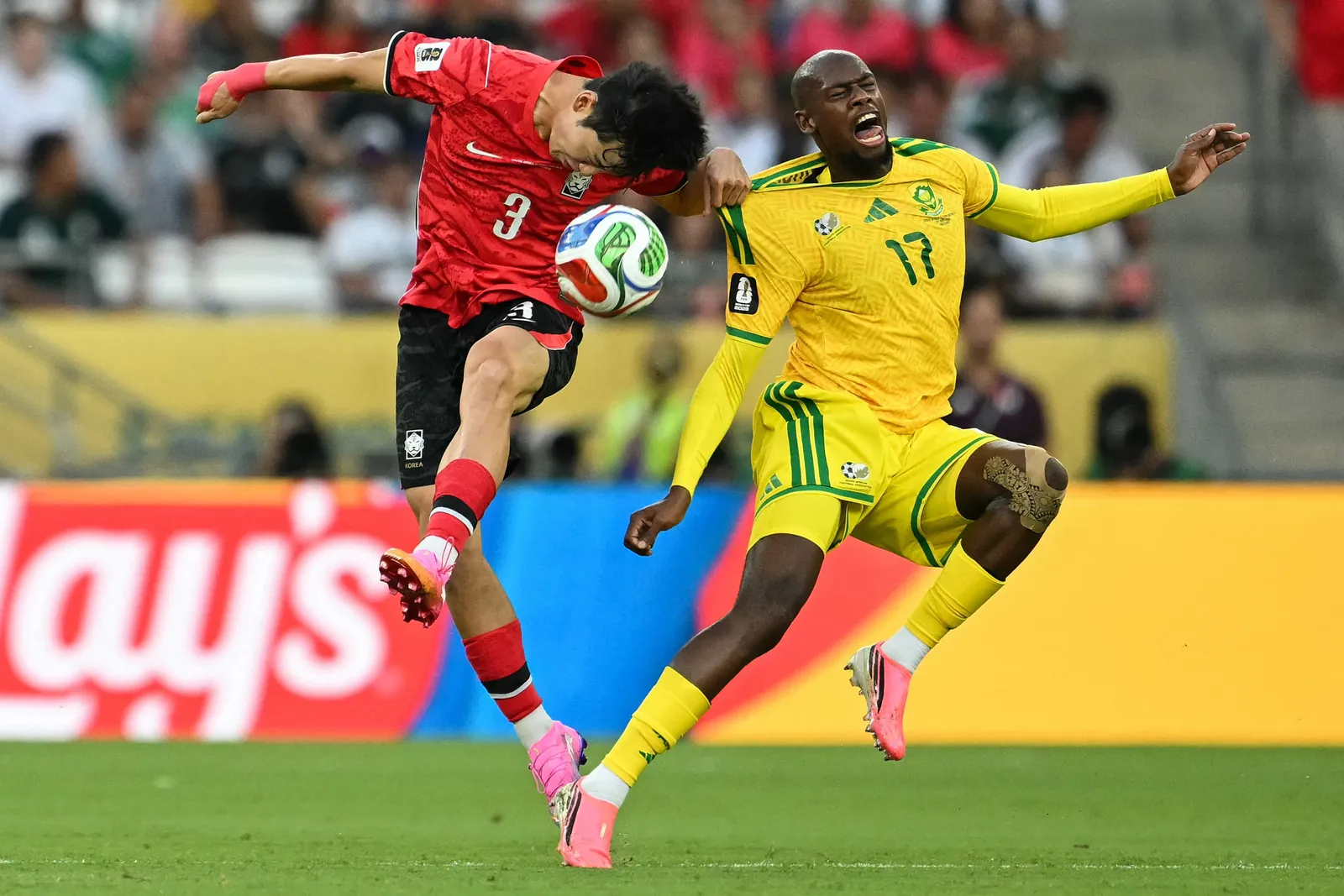 South Korea's defender #03 Lee Gi-hyuk and South Africa's forward #17 Evidence Makgopa fight for the ball during South Africa and South Korea game.