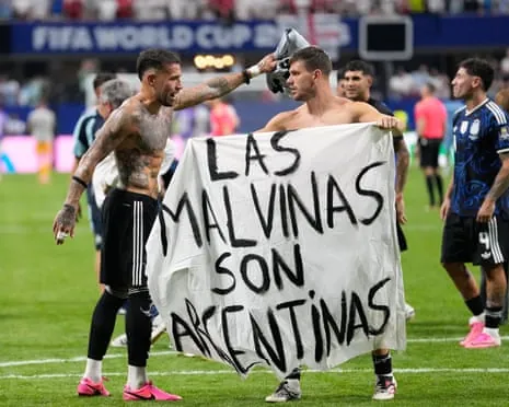 Argentina’s Giovani Lo Celso holds a banner with the words ‘the Malvinas are Argentinian’ after their semi-final win over England