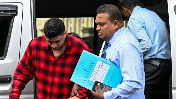 Lanka Premier League (LPL) franchise Jaffna Kings team co-owner Manjot Kalra (L) is taken to court after being arrested by the Sri Lanka Sports Investigation Unit for alleged match-fixing in Colombo.