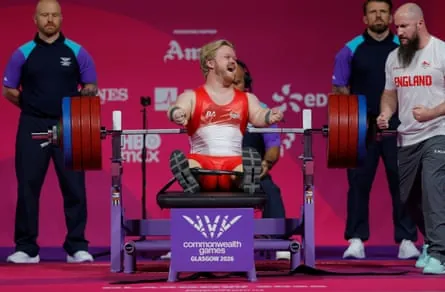 England’s Mark Swan celebrates after a successful lift on his way to gold